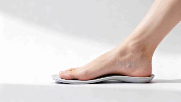 Low arch foot standing on firm arch support insole designed for flat feet alignment