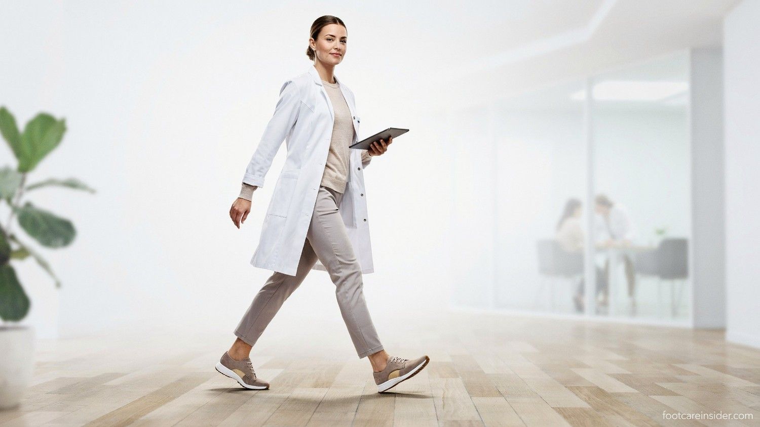 Adult walking comfortably in supportive shoes with visible insole support in a clean healthcare editorial setting focused on daily walking and standing comfort.