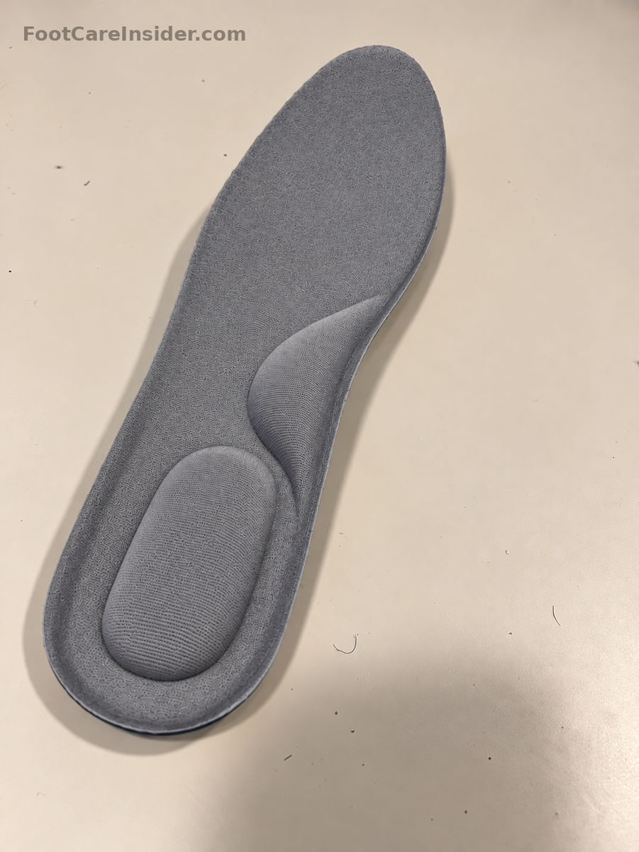 Gray memory foam insole on a cream surface